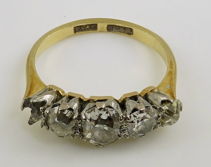 An early 20th century 18ct gold, platinum and graduated five stone old mine cut diamond set half hoop ring(one stone missing)